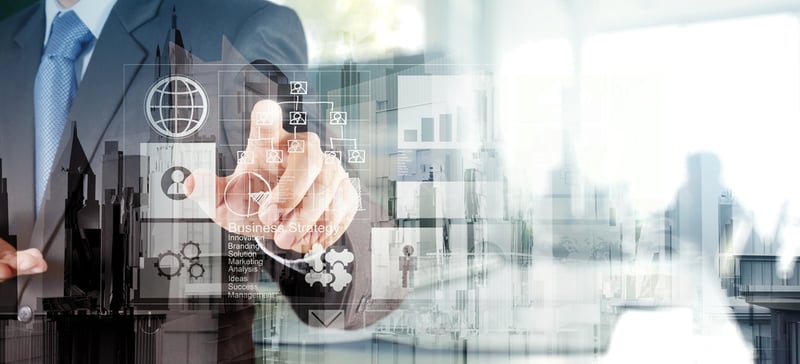Double exposure of businessman hand working with new modern computer and business strategy as concept