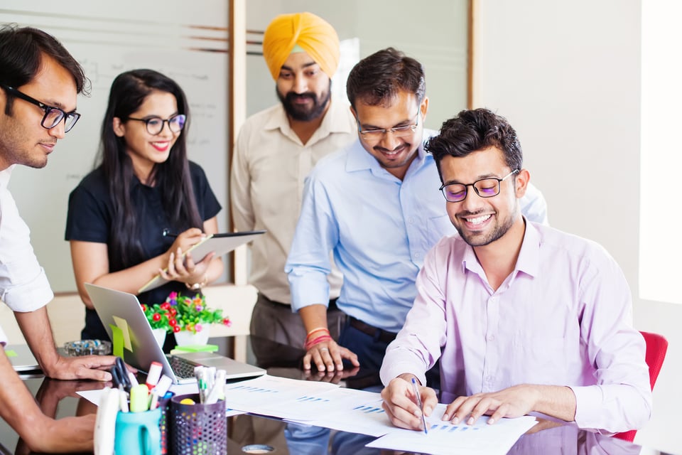 Indian American business team is excited by the growth in their company after securing new clients.